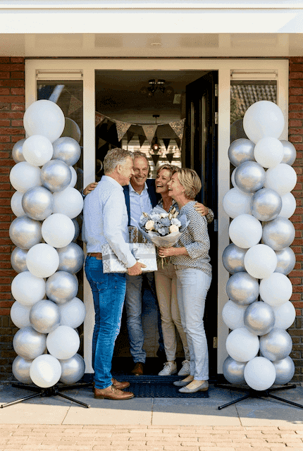 Double silver balloon column setup at entrance for 25th wedding anniversary celebration
