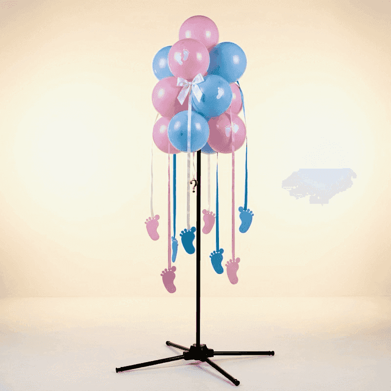 Adorable gender reveal balloon cluster with hanging pink and blue baby footprints, white bow and golden question mark