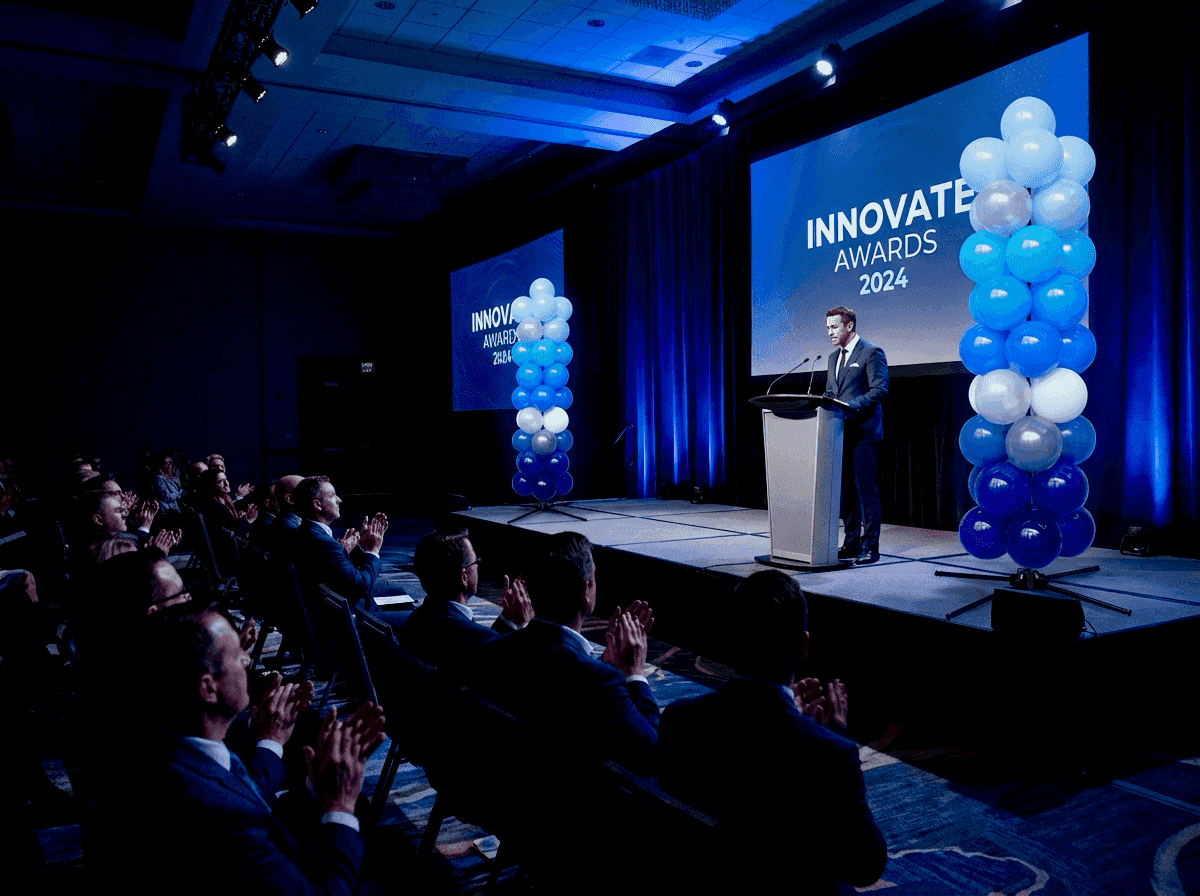 Balloon pillars as stage accent at corporate award ceremony