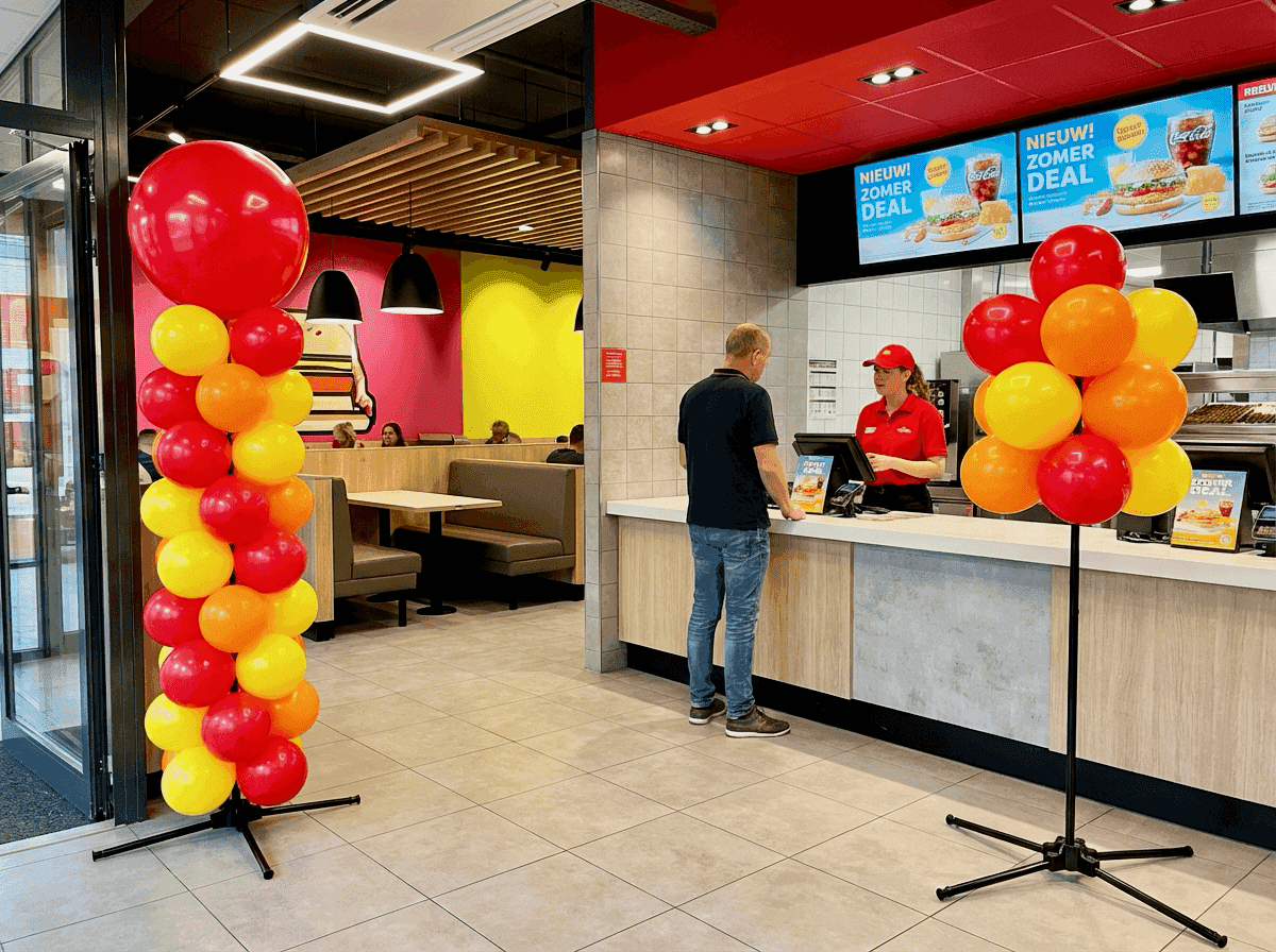 Quick service restaurant with red and yellow balloon decoration for a promotion