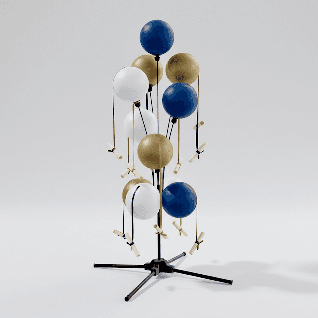 PilaMania balloon signage display in school colours next to lectern on stage during graduation ceremony
