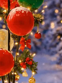Pine greenery with red bows and lights among red balloons